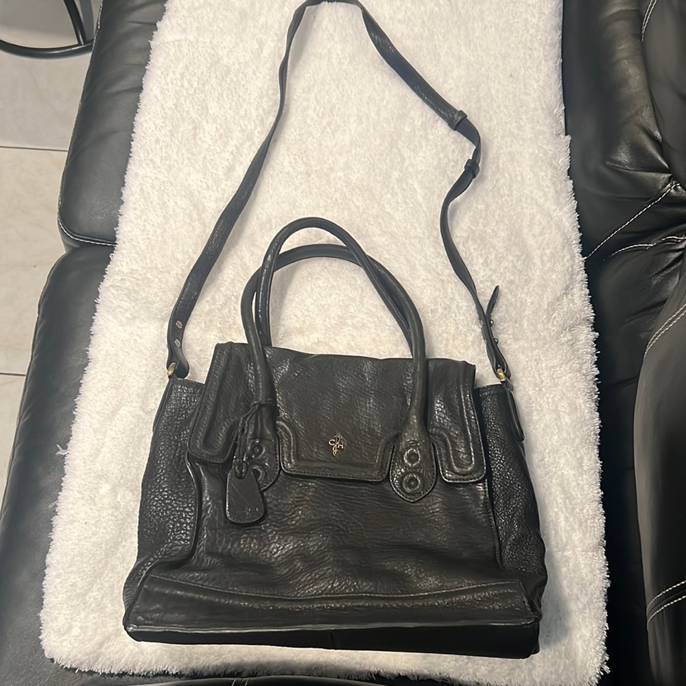 Black Cole Haan purse with multiple pockets inside
